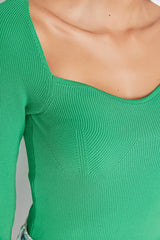green knit top